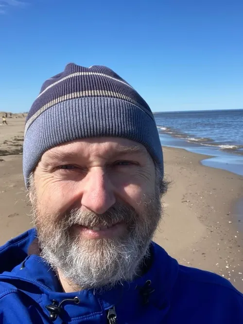 John Cormier on a beach in New Brunswick
